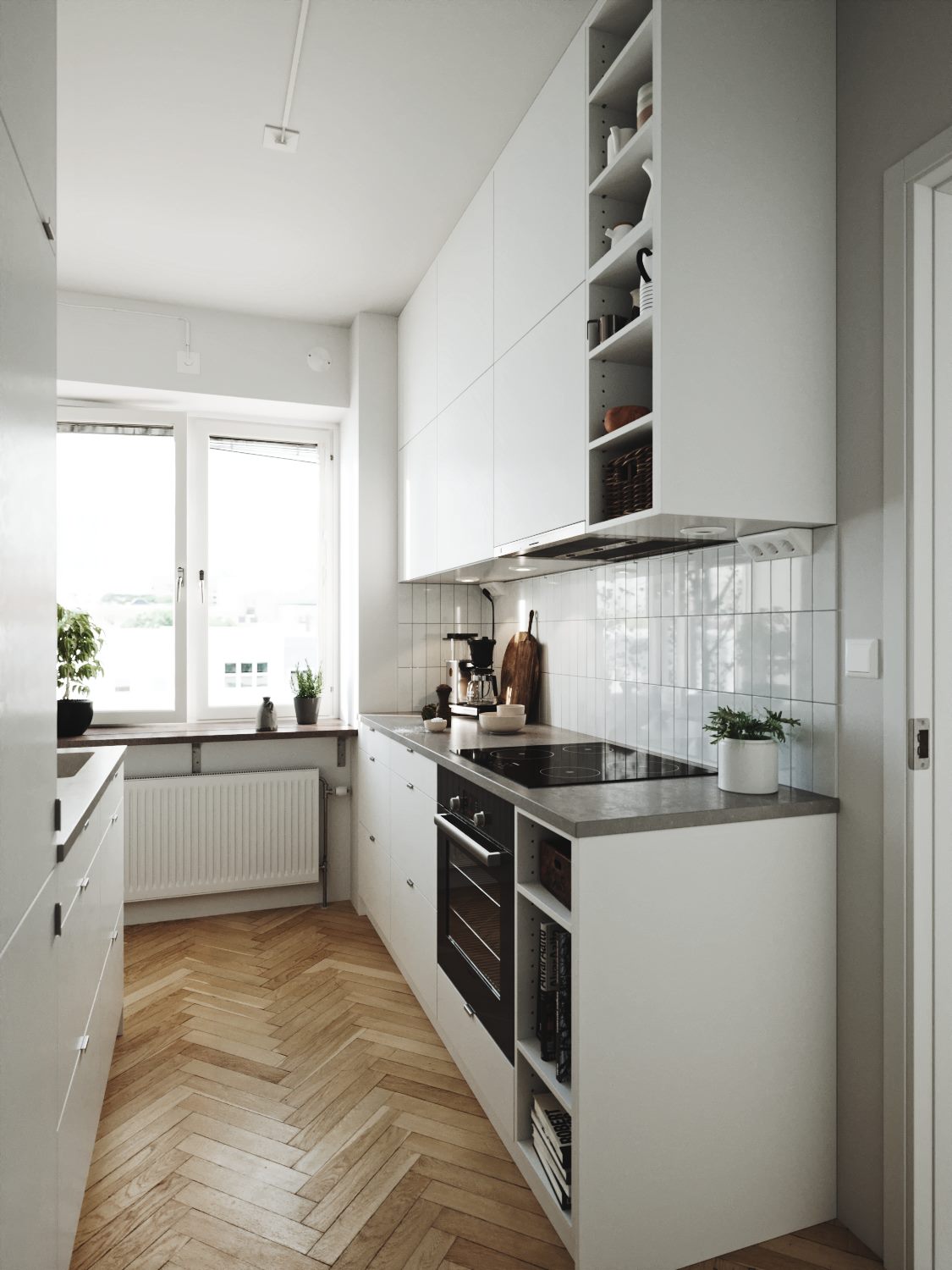 Narrow white kitchen with a herringbone wood floor and a window at the end