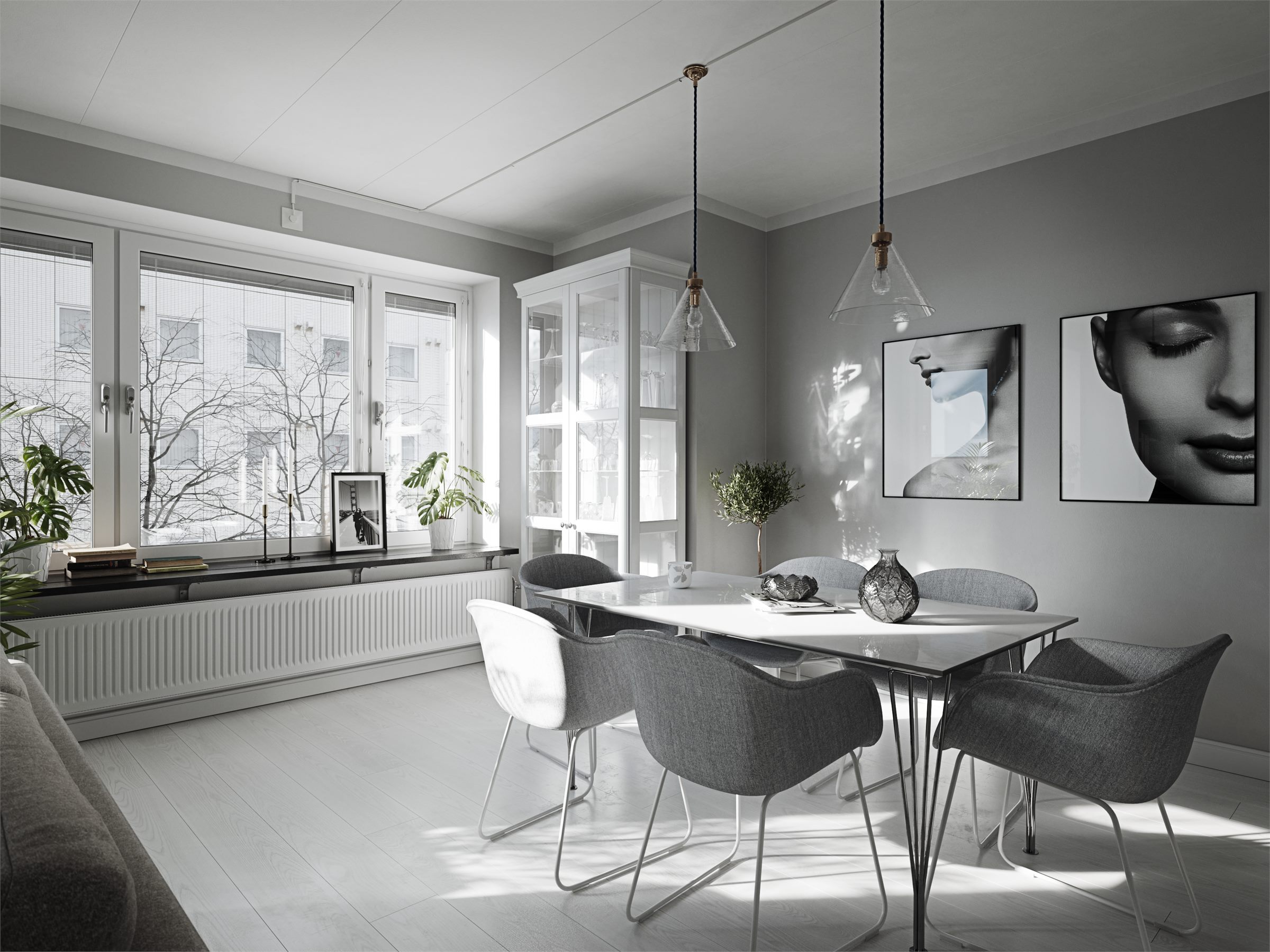 Dining table with grey chairs beneath pendant lights, by a row of windows